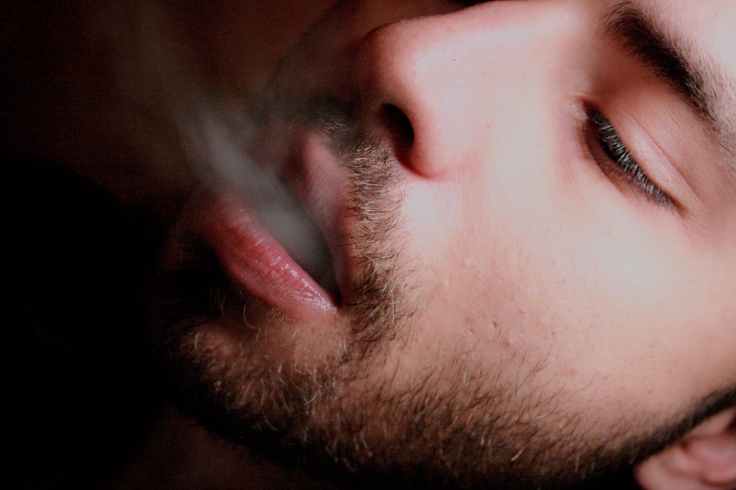 adult beard cigarette close up