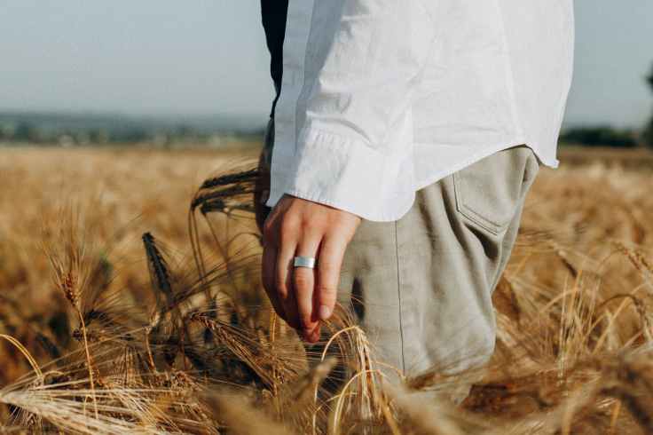 close up photo of person standing on wheat field